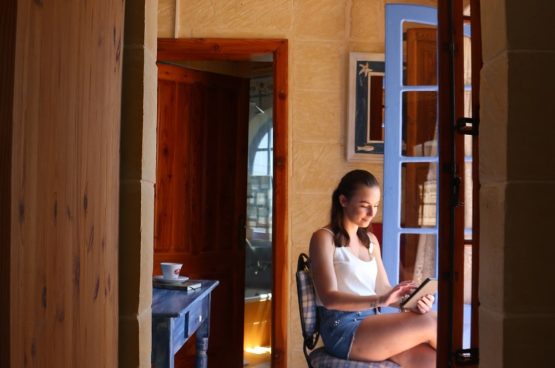 enjoying-a-book-at-il-Wileg-bed-and-breakfast-in-Gozo-min